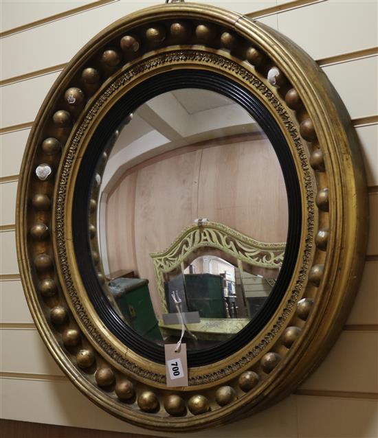 A Regency style gilt gesso convex wall mirror, Diam.70cm